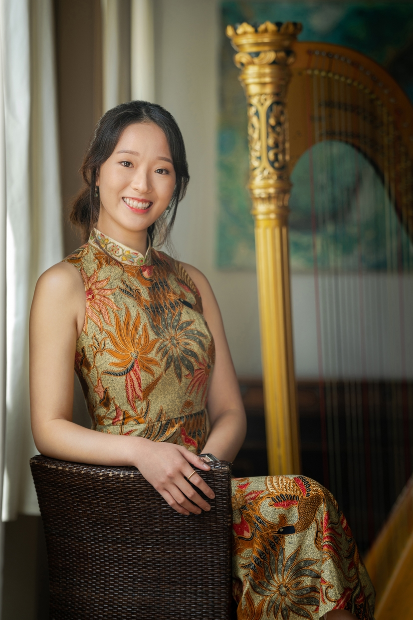 Karen smiling next to Harp