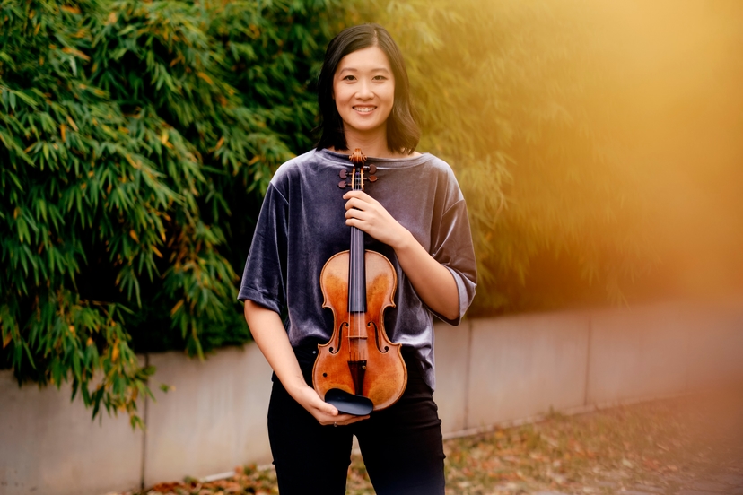Christine Wu smiling with Violin in hand
